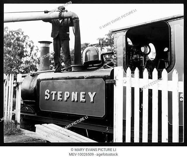 The locomotive 'Stepney' taking on water at the Bluebell Railway, Sheffield Park, Sussex, England