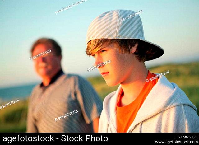 Serious teen with father