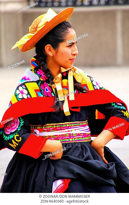 Young local woman performing suring Festival of the Virgin de la Candelaria in Lima, Peru. The core of the festival is dancing and music performed by different...
