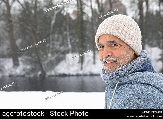 Smiling man wearing knit hat at park