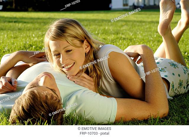 Young couple lying on meadow