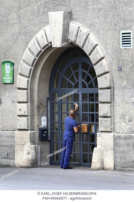 A man cleans the windows of the entrance door of the prison in Landsberg am Lech, Germany, 02 June 2014. According to media reports on 02 June 2014, Hoeness