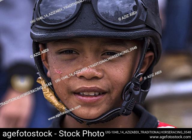Rizkan Abadi is still 13 years old, the little jockey who has gained many champions in the race, gets ready to race horses at HM Hasan Field, Blang Bebangka