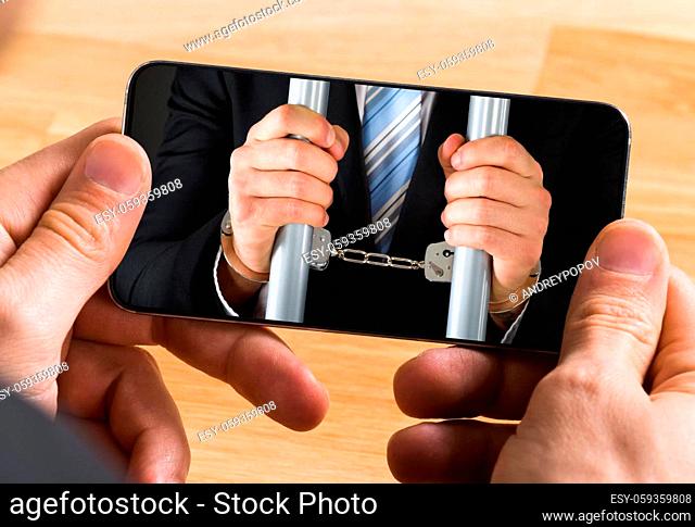 Close-up Of Young Businessman Hand Holding Smartphone Showing Online Survey Form