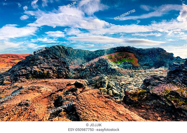 Fields of steamy waters in the Krafla volcano. Colorful exotic landscape with lava ground in the geothermal valley Leirhnjukur