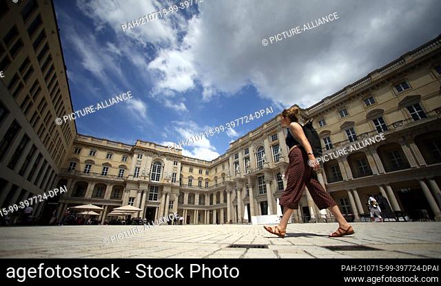 15 July 2021, Berlin: A woman walks through the Schlüterhof of the Humboldt Forum. The rebuilt Berlin City Palace opens on 20 July with several exhibitions