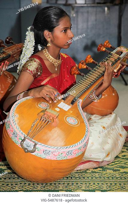 Tamil Hindu girl performs a devotional song on the veena during the Mancham Narayanan Perumaal Festival (which honours Lord Vishnu) at a Tamil Hindu temple in...