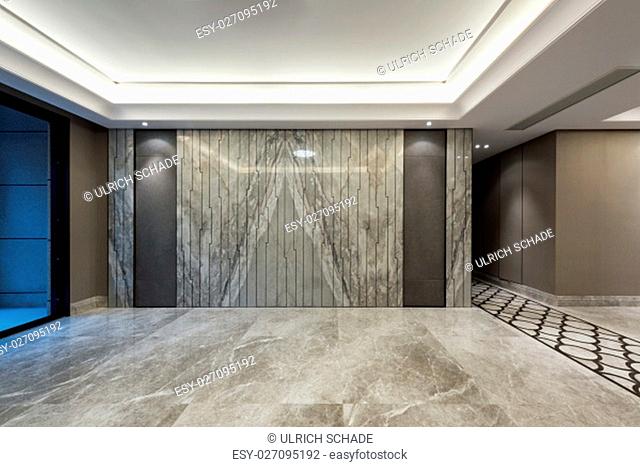 Empty room with grey marble flooring and wall decoration