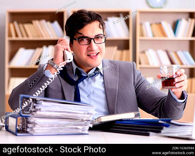 The young businessman drinking from stress
