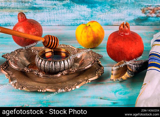 Rosh hashanah with glass honey jar and fresh ripe apples. Jewesh new year symbols shofar and tallit