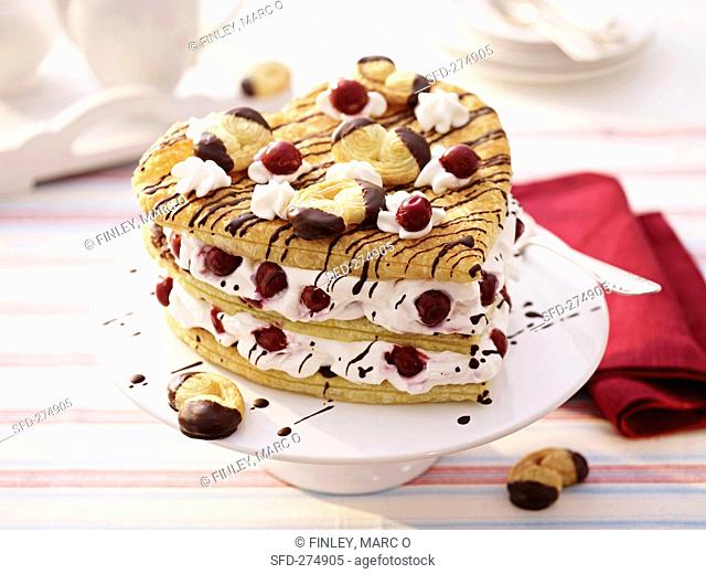 Puff pastry heart with cream and cherries