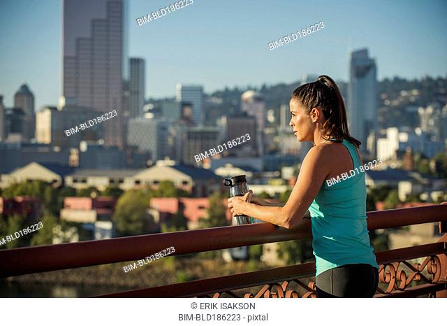 Caucasian woman admiring Portland cityscape, Oregon, United States