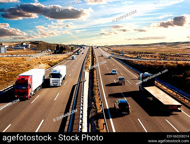 International shipment, trucks and cars driving on the road.Logistics and warehousing