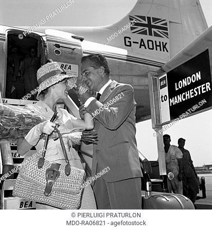 Italian actor Rossano Brazzi shaking French actress Leslie Caron's hand just after she arrived at Ciampino airport. Rome, 24th July 1959