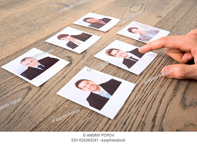 Close-up Of A Businessman Choosing Candidates At Desk In Office