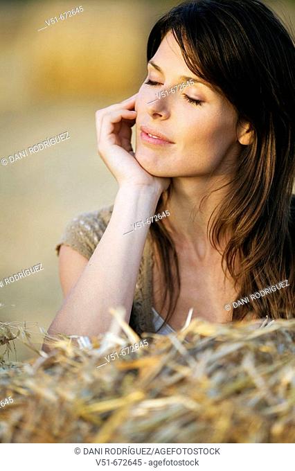 Woman outdoors with eyes closed feeling good
