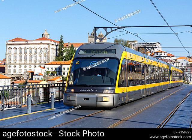 Modern light rail Metro do Porto tramway public transport transport traffic on the bridge Ponte Dom Luis I in Porto, Portugal, Europe