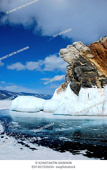 Rocky cliff in winter. Frozen lake Baikal view