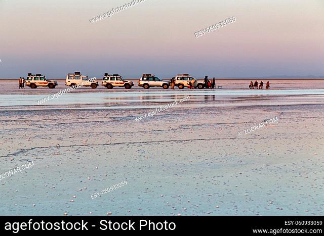 in danakil ethiopia africa in the lake for the saline lots of car and people watching the sun in relax