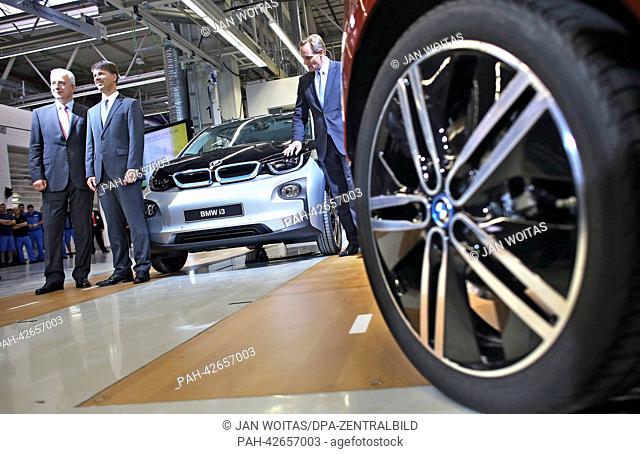 Saxony's Premier Stanislaw Tillich (L-R), BMW board member for production Harald Krueger and mayor of Leizig Burkhard Jung celebrate the production launch of...