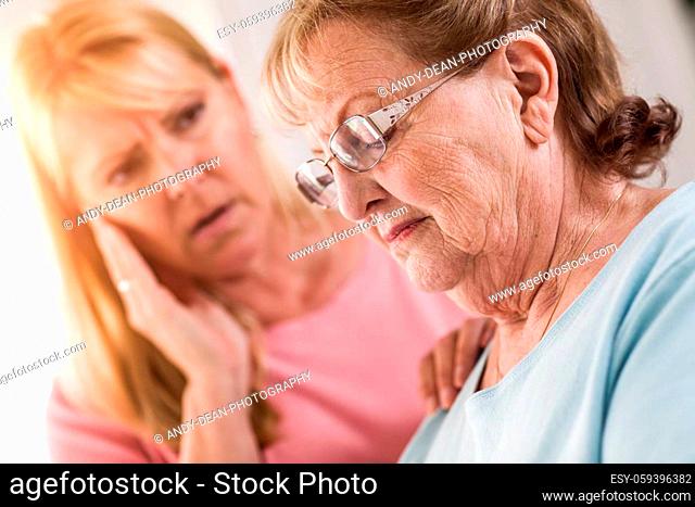 Young Adult Woman Consoles Sad Senior Adult Female