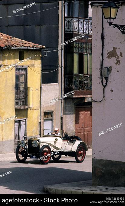 Hispano Suiza car rally - Santander to Madrid. Edward John Barrington Douglas-Scott-Montagu, 3rd Baron Montagu of Beaulieu, drives though a Spanish village