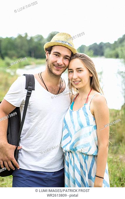 Portrait of happy couple on the riverbank