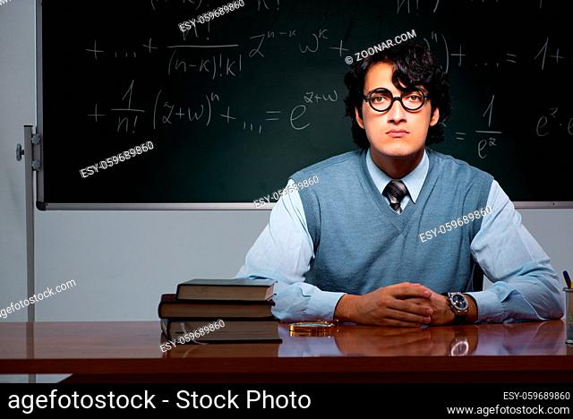 Young math teacher in front of chalkboard