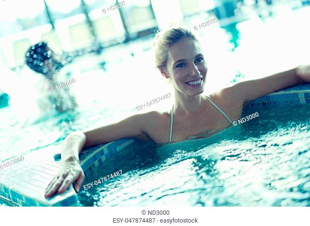 Woman relaxing in spa pool with bubble bath