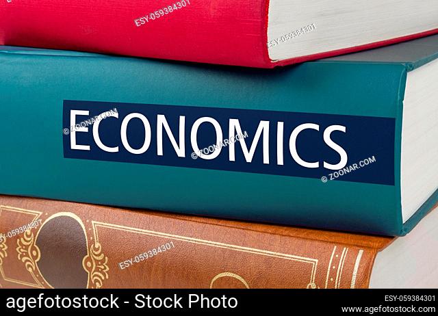 A book with the title Economics written on the spine