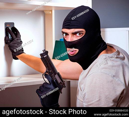 The burglar wearing balaclava mask at crime scene
