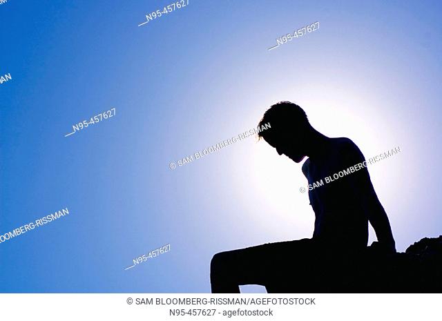 Silhouette of a man on a rock. Nerja, Spain