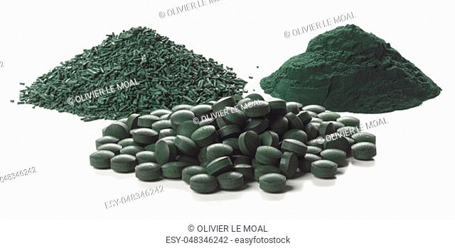 Close up of organic spirulina tablets, flakes and powder over white background