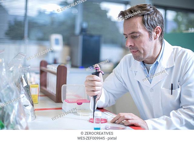 Scientist pipetting in lab