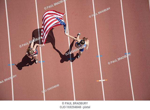 Runners celebrating on track with American flag