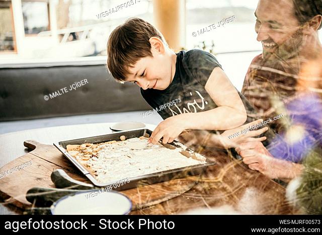Son preparing food with father
