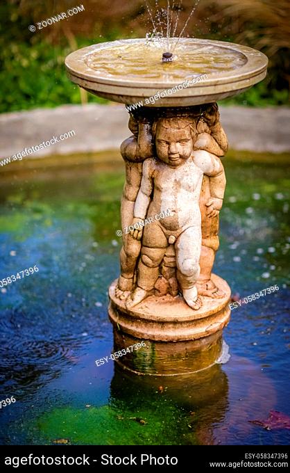 Small fountain in the Rookery in Streatham Common Park in London, UK