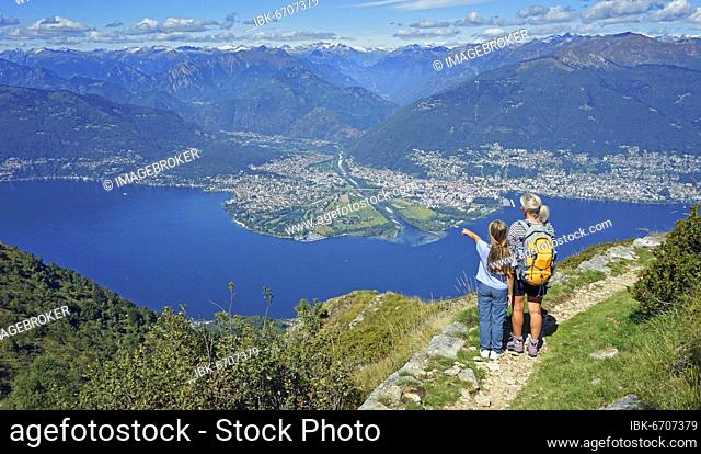 Mother and daughter looking at the Maggia delta with Ascona and Locarno at the end of the Valle Maggia, Monte Gambarogno, Lago Maggiore, Ticino, Switzerland