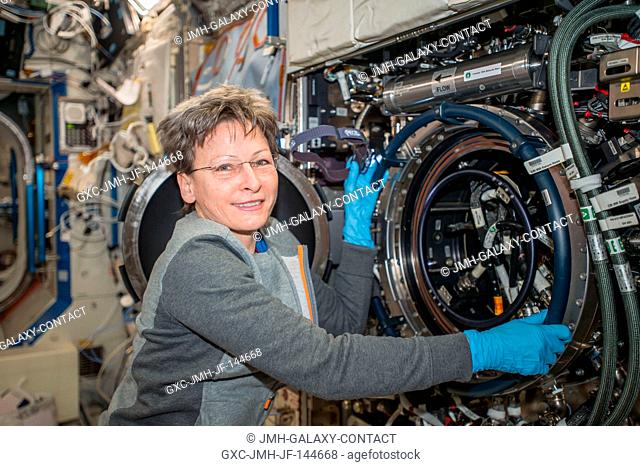 Astronaut Peggy Whitson works on the Combustion Integrated Rack in the U.S. Destiny laboratory module