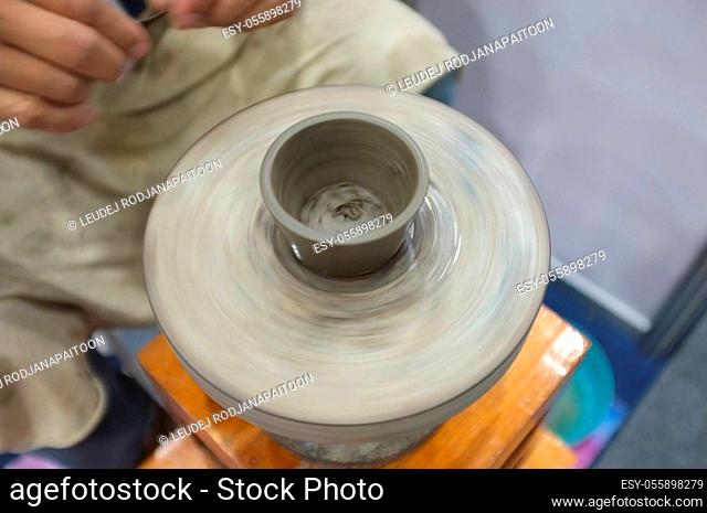 Concept Ceramic workshop. The man Throwing clay bowl on a pottery's wheel