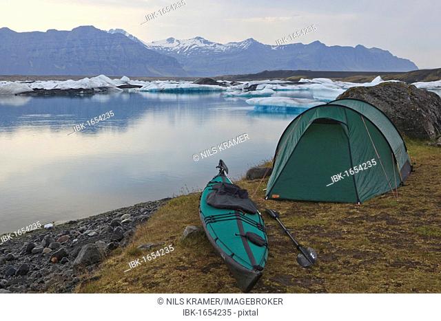 Overnight camp with a tent and a folding kayak beside the Joekulsarlon glacial lake, Iceland, Europe