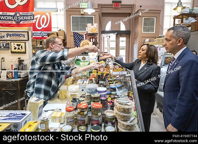 United States Vice President Kamala Harris, center, receives a sample of cheese before making a purchase at Bowers Fancy Dairy Products Stand No