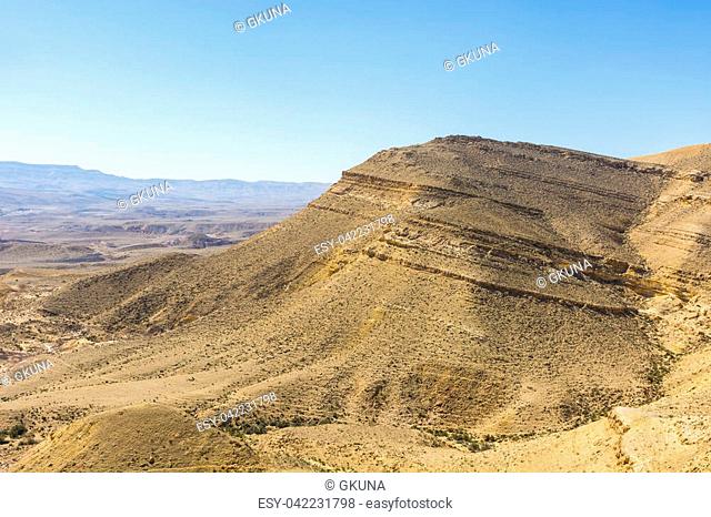 Rocky hills of the Negev Desert in Israel. Breathtaking landscape of the rock formations in the Southern Israel. Dusty mountains interrupted by wadis and deep...