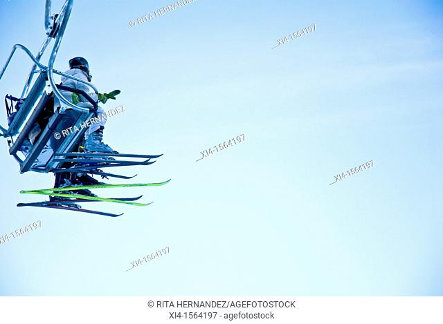 Skiers in the chairlift. Blue sky as background. Copy space. Grouse Mountain. North Vancouver, British Columbia in Canada