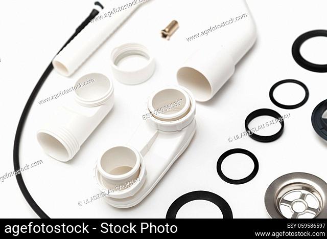 Details plastic siphon kit for bathtub on a white background. Plumbing knolling on white background