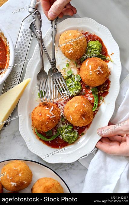 Arancini with tomatoes on a dish