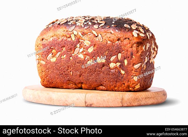 Unleavened bread with seeds and dried fruit on wooden board isolated on white background