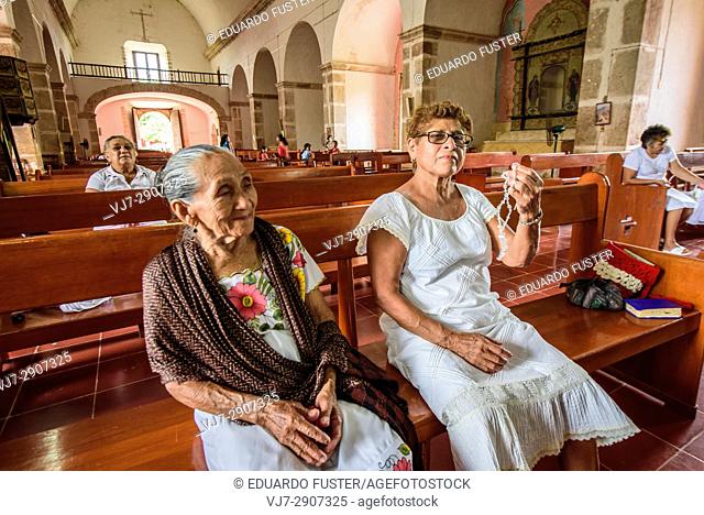 Women praying in the church of the convent of Mama, Yucatan (Mexico)