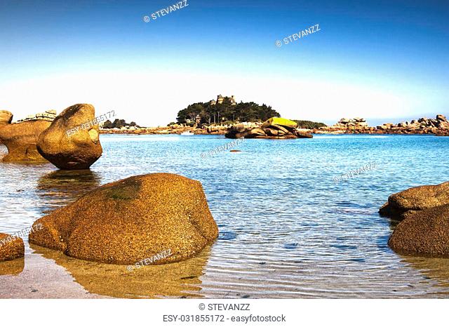 Ploumanach, ock and bay beach in morning. Toned. Pink granite coast, Perros Guirec, Brittany, France. Long exposure