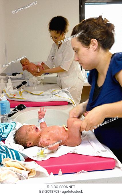 Photo essay from hospital. Mother-child center. Hospital of Meaux 77, France. Nursery, washing tof the newborn babies. In foreground newborn baby boy and his...